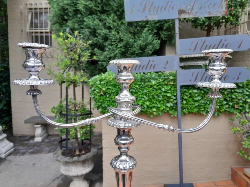 A 20TH Century Pair of Silver Plated Embossed Candelabra