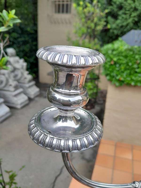 A 20TH Century Pair of Silver Plated Embossed Candelabra
