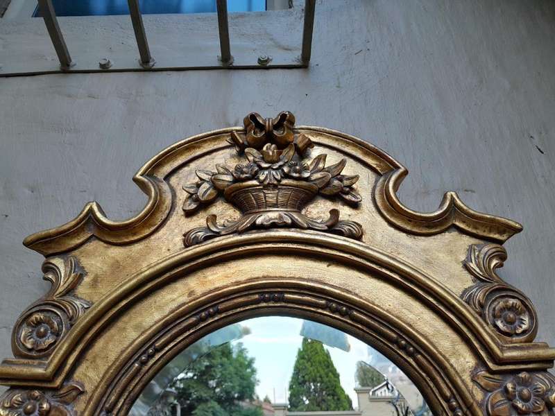 A 20th Century Carved and Gilded Bevelled Oval Mirror