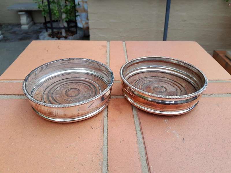 A 20th Century Pair of Silver- plate Wine Coasters with Wooden Bases