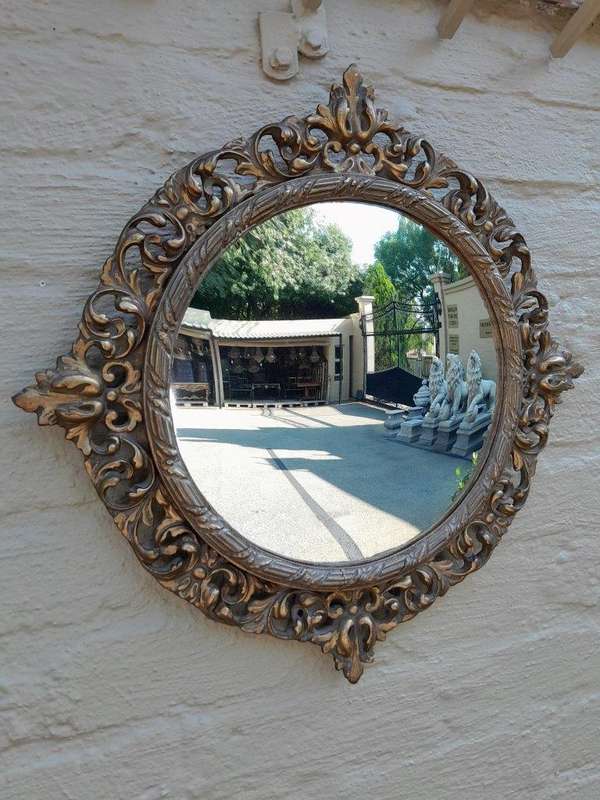 An Early 20th Century Circa 1920 Ornately Carved Giltwood Convex Mirror