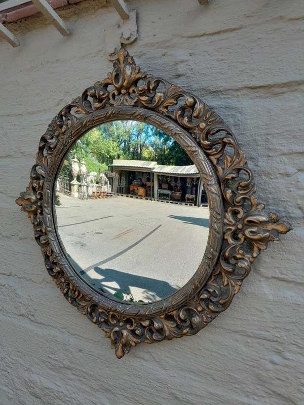 An Early 20th Century Circa 1920 Ornately Carved Giltwood Convex Mirror