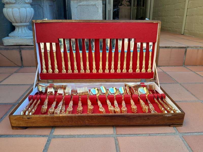 A Canteen Of 24kt 12 Place Ornately Gold Plated Stainless Steel Cutlery Set