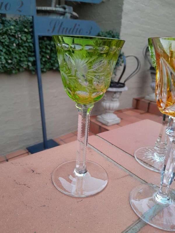 A 20th Century Collection Of Seven Coloured Bohemian Cut Crystal Wine Glasses