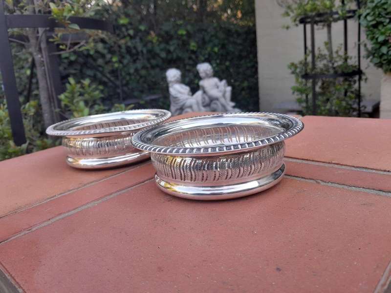 A 20th Century Pair Of Mappin & Webb Silver Plated Wine Coasters