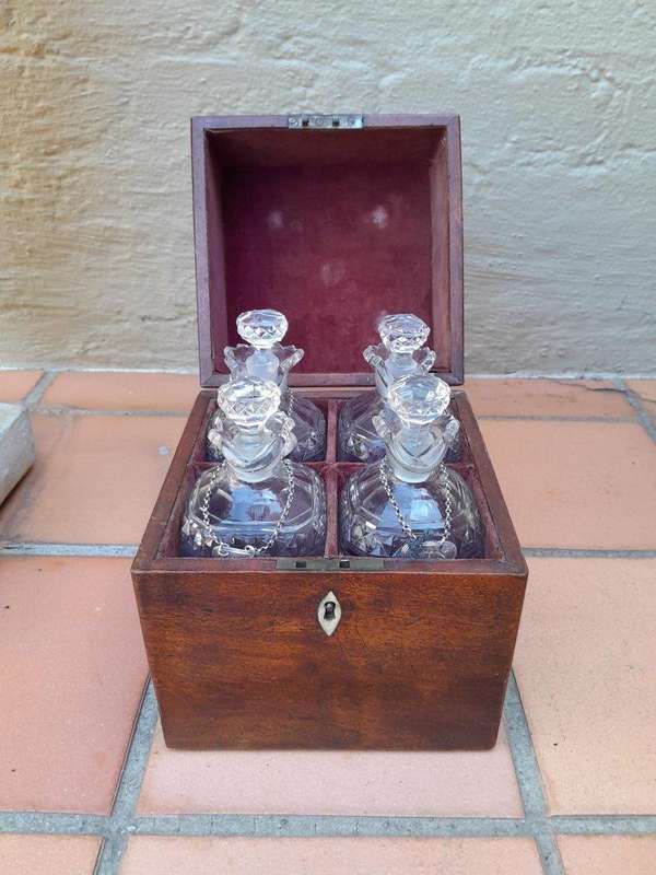An 18th / Early 19th Century Georgian Mahogany Tantalus With Four Cut Glass Decanters And Three G...