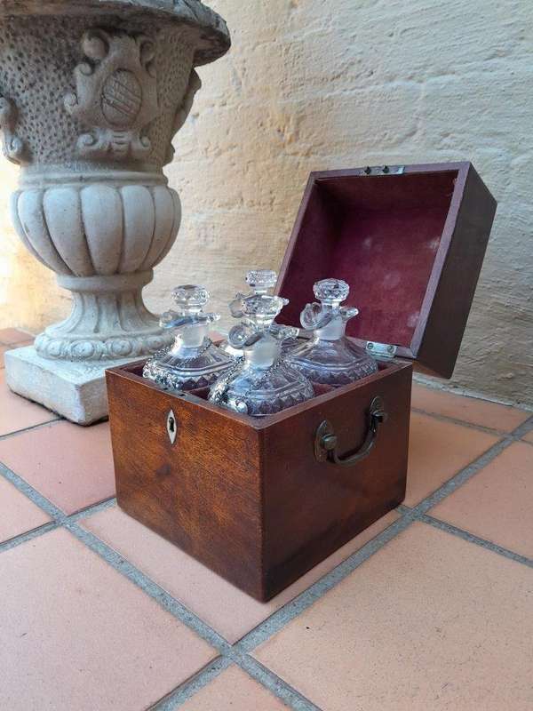 An 18th / Early 19th Century Georgian Mahogany Tantalus With Four Cut Glass Decanters And Three G...
