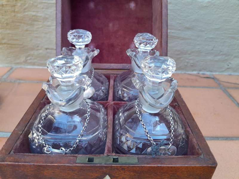 An 18th / Early 19th Century Georgian Mahogany Tantalus With Four Cut Glass Decanters And Three G...