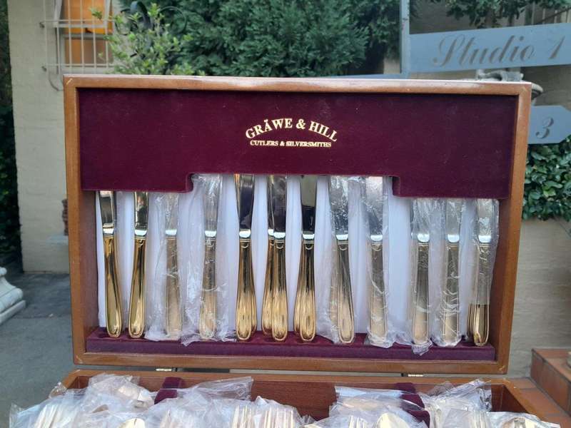 A Grawe And Hill Gold-Plated Cutlery Set With Maroon Lining In A Canteen