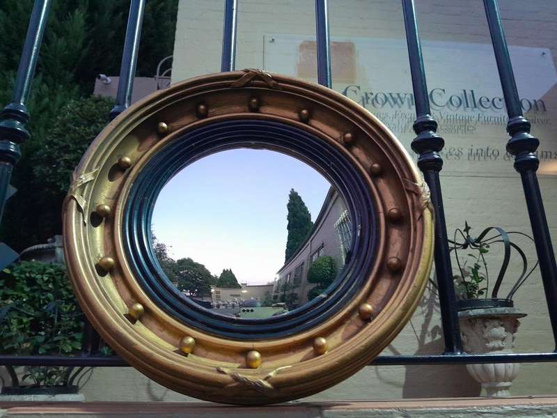 A 20TH Century Regency Style Gilt Painted Ebonised Convex Mirror