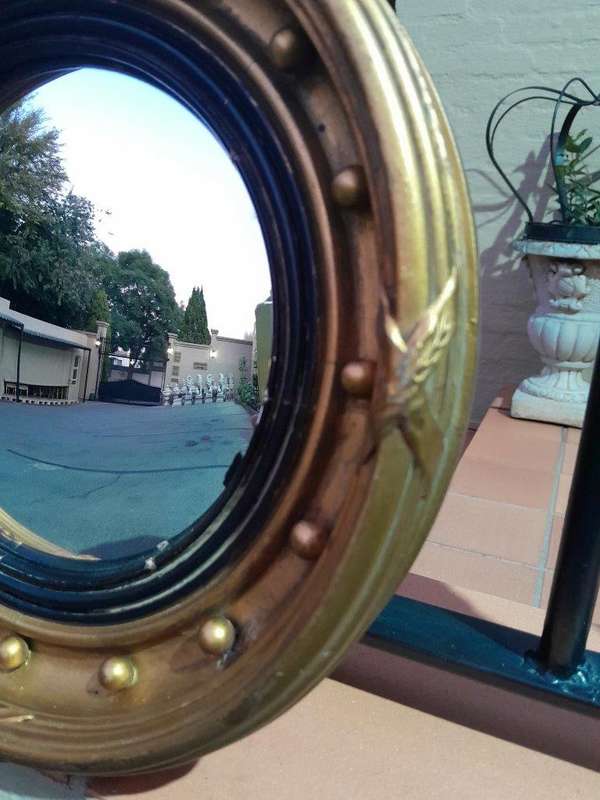 A 20TH Century Regency Style Gilt Painted Ebonised Convex Mirror