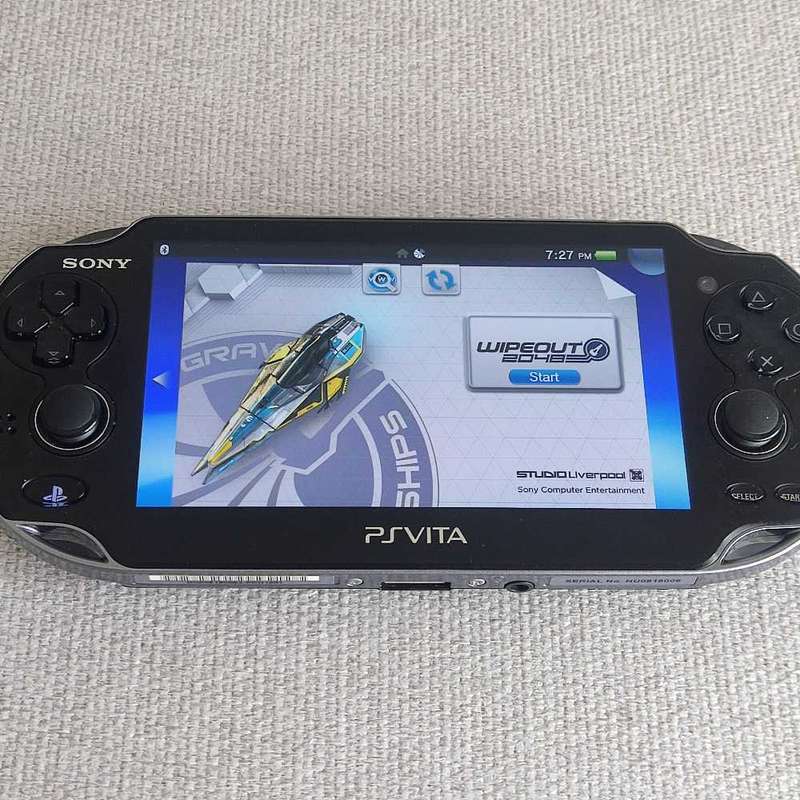 Playstation Vita (Ps Vita) handheld console with charger and memory card