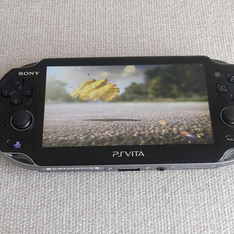 Playstation Vita (Ps Vita) handheld console with charger and memory card