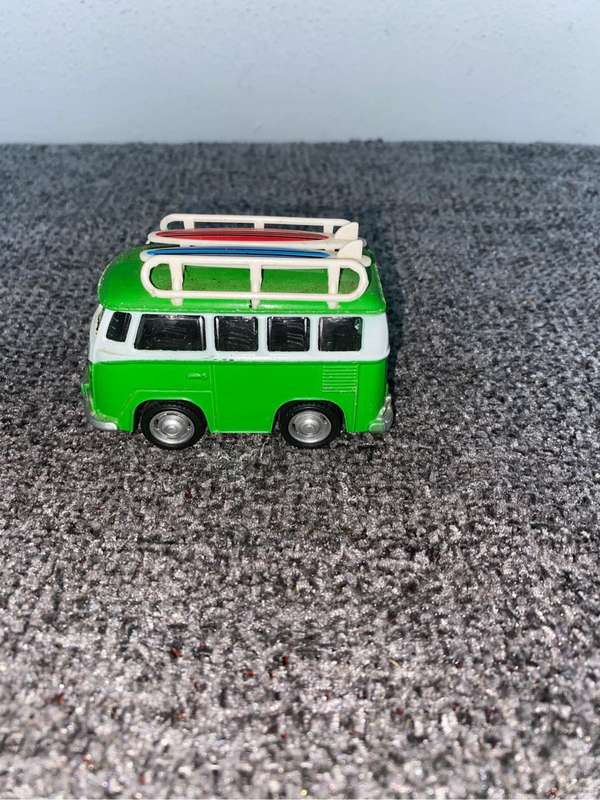 Green VW Minibus with a surfboard