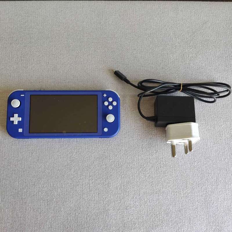 Nintendo Switch Lite console with original charger