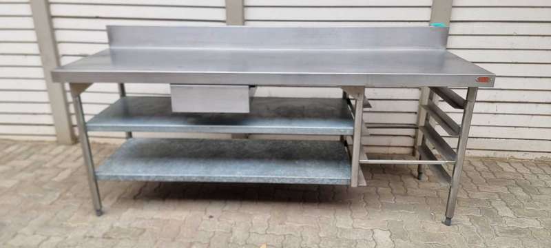 Stainless steel butcher table (Vulcan) with shelves and splashback.