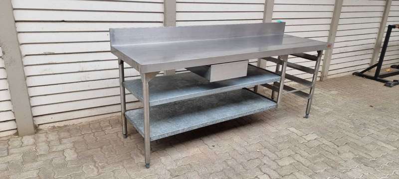 Stainless steel butcher table (Vulcan) with shelves and splashback.