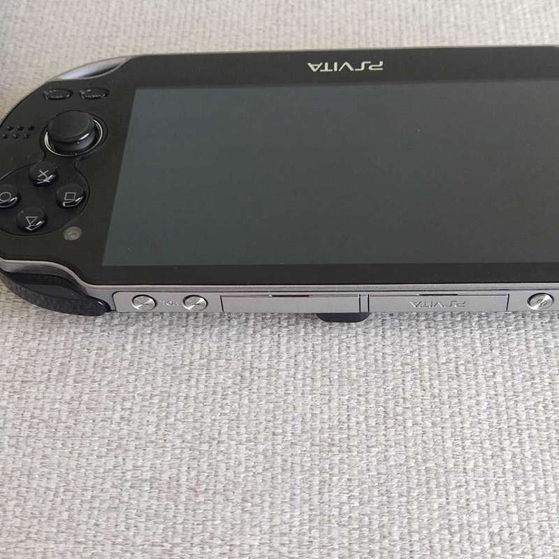 Playstation Vita (Ps Vita) handheld console with charger and memory card