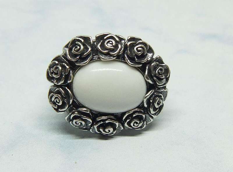 A STUNNING VINTAGE SOLID STERLING SILVER RING WITH WHITE CABOCHON STONE INSET AND ROSE DETAIL