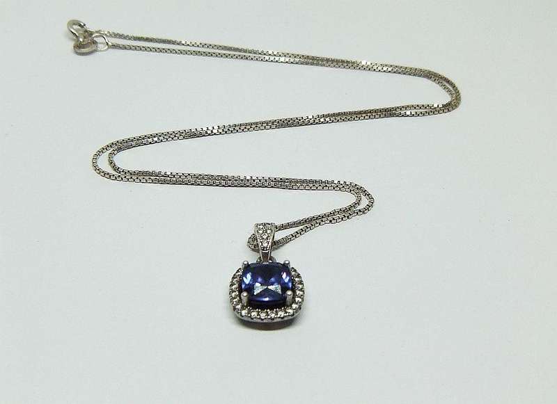 Sterling silver pendant with faceted blue inset and necklace