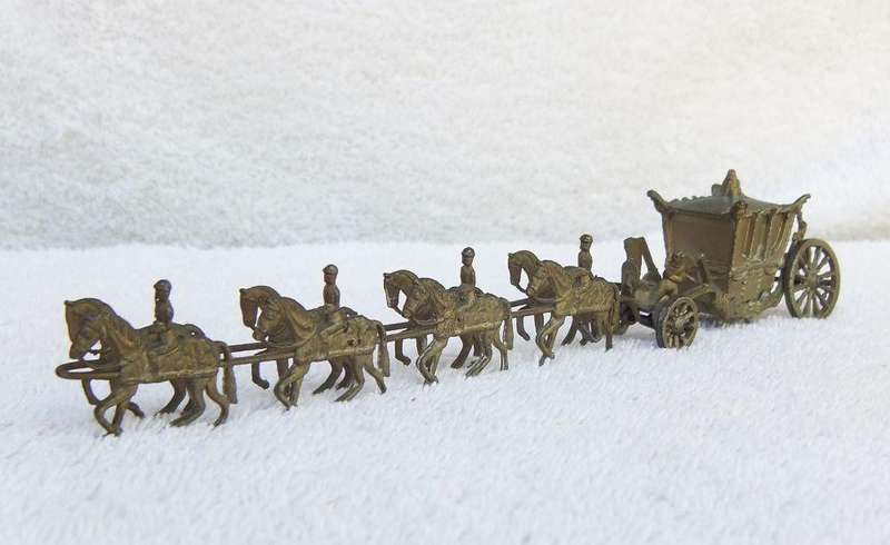AN OLD METAL HORSE AND COACH ORNAMENT