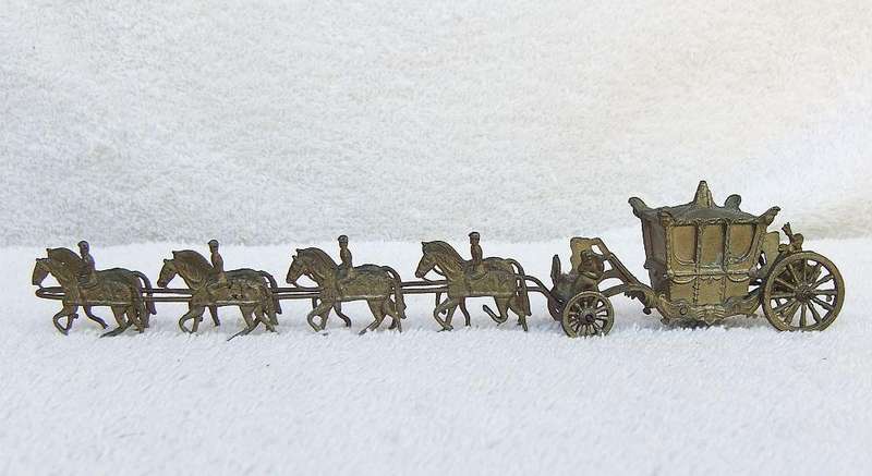AN OLD METAL HORSE AND COACH ORNAMENT
