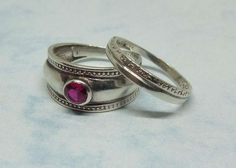 Solid sterling silver two piece ring set with faceted red stone feature