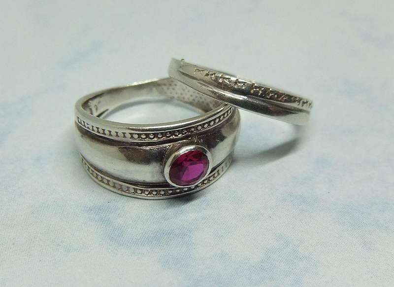 Solid sterling silver two piece ring set with faceted red stone feature