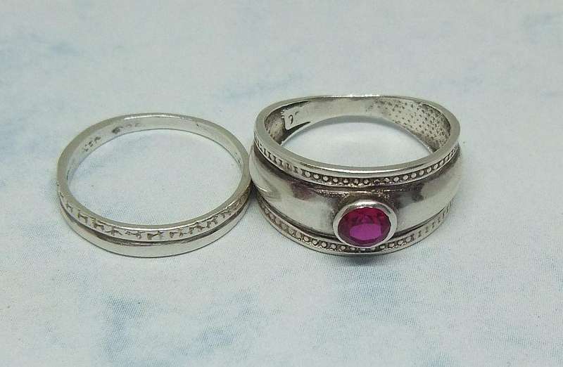Solid sterling silver two piece ring set with faceted red stone feature