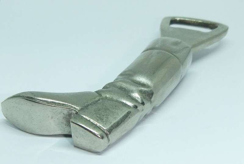 A VINTAGE SOLID METAL BOOT FORM BOTTLE OPENER