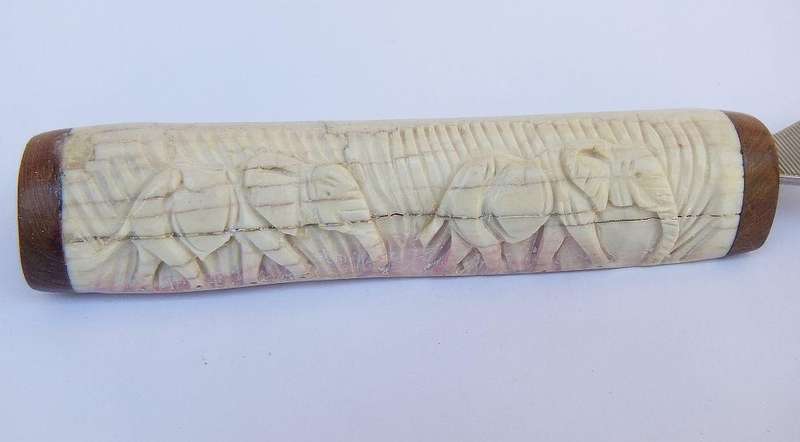 A UNIQUE VINTAGE CARVED BONE AND WOOD BOTTLE OPENER WITH ELEPHANT DETAIL - NEVER USED