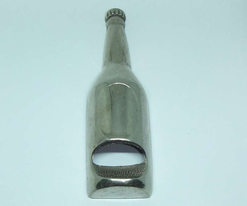 A VINTAGE BOTTLE FORM BOTTLE OPENER