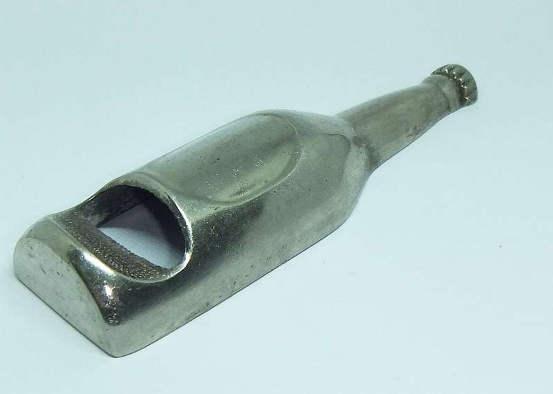 A VINTAGE BOTTLE FORM BOTTLE OPENER