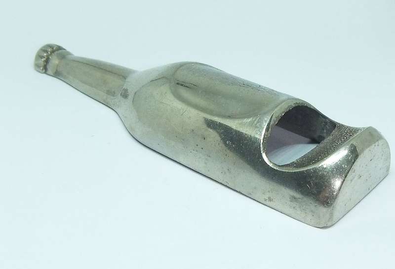 A VINTAGE BOTTLE FORM BOTTLE OPENER