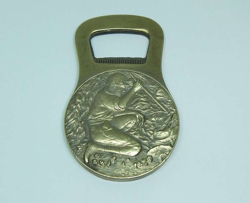 A VINTAGE MINING RELATED SOLID BRONZE BOTTLE OPENER