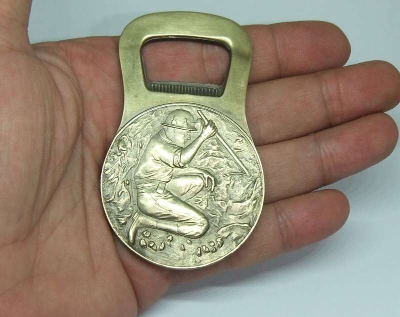 A VINTAGE MINING RELATED SOLID BRONZE BOTTLE OPENER
