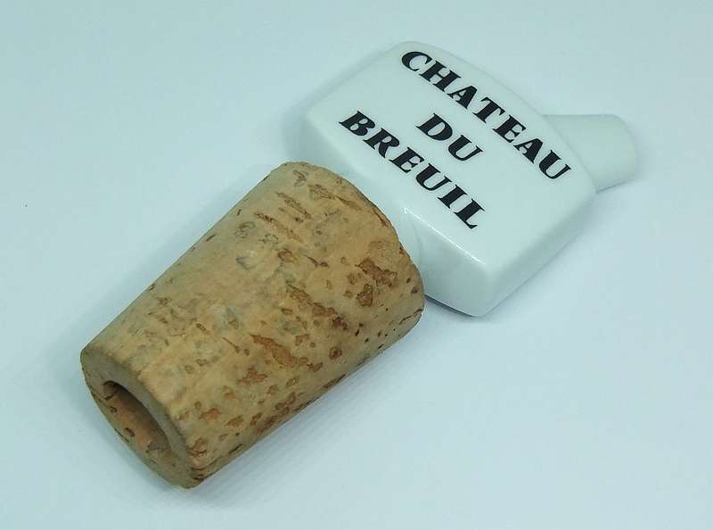 A VINTAGE PORCELAIN AND CORK ALCOHOL POURER