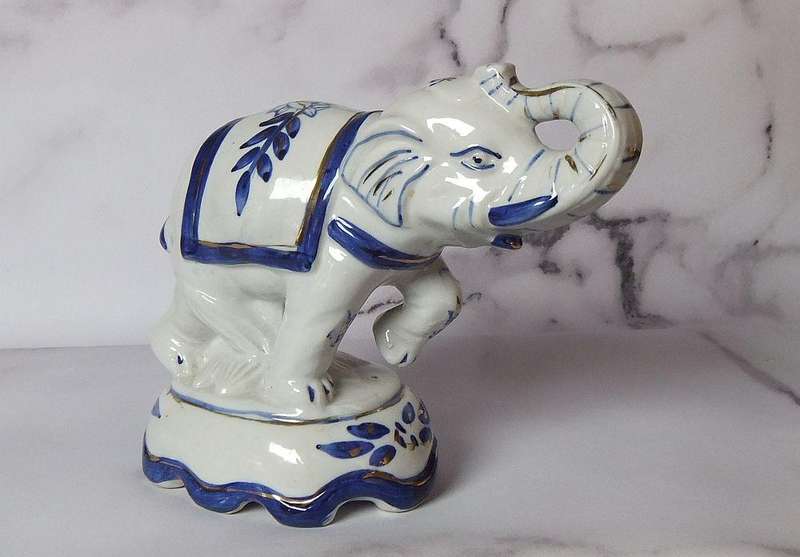 AN EYE CATCHING VINTAGE HANDPAINTED AND GLAZED CLAY ELEPHANT ON PLINTH IN EXCELLENT CONDITION