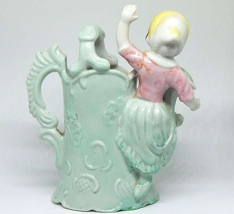 A RATHER KITSCH VINTAGE GIRL SITTING ON A WATERING CAN FIGURINE FLOWER POT IN GOOD CONDITION !!