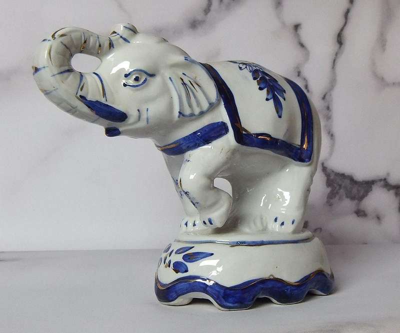 AN EYE CATCHING VINTAGE HANDPAINTED AND GLAZED CLAY ELEPHANT ON PLINTH IN EXCELLENT CONDITION