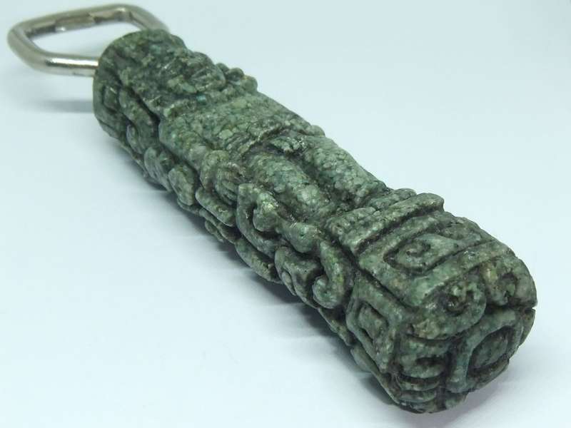 A VINTAGE BOTTLE OPENER WITH AZTEC MOTIF