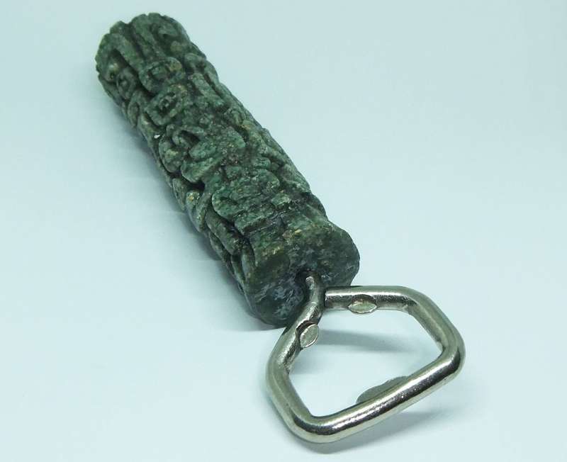 A VINTAGE BOTTLE OPENER WITH AZTEC MOTIF