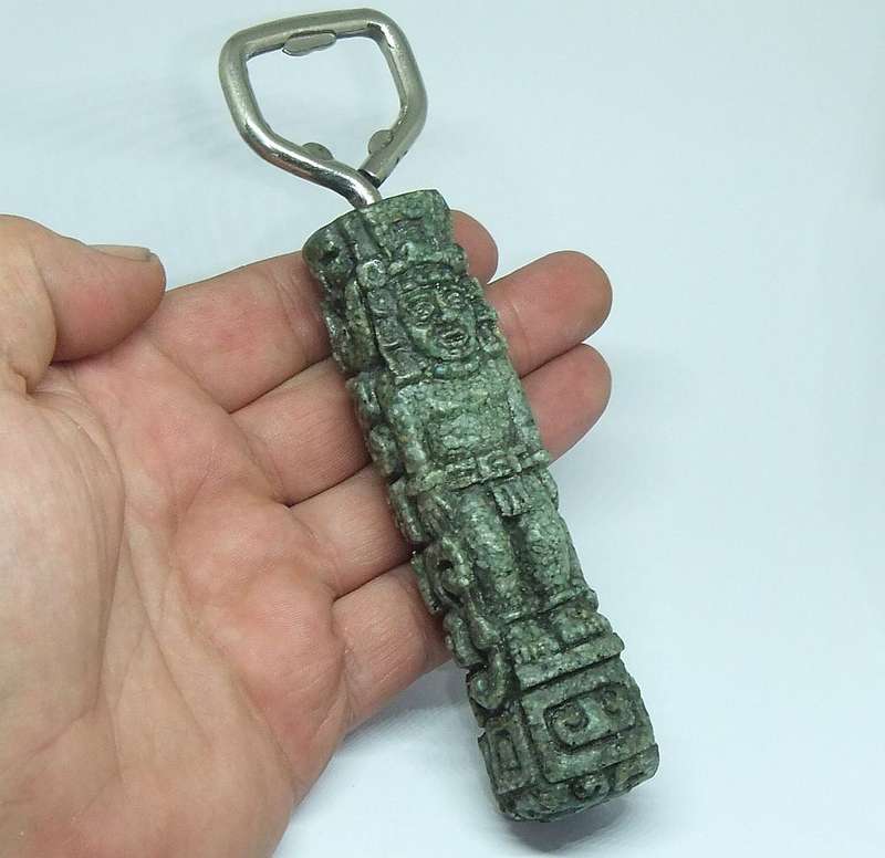 A VINTAGE BOTTLE OPENER WITH AZTEC MOTIF