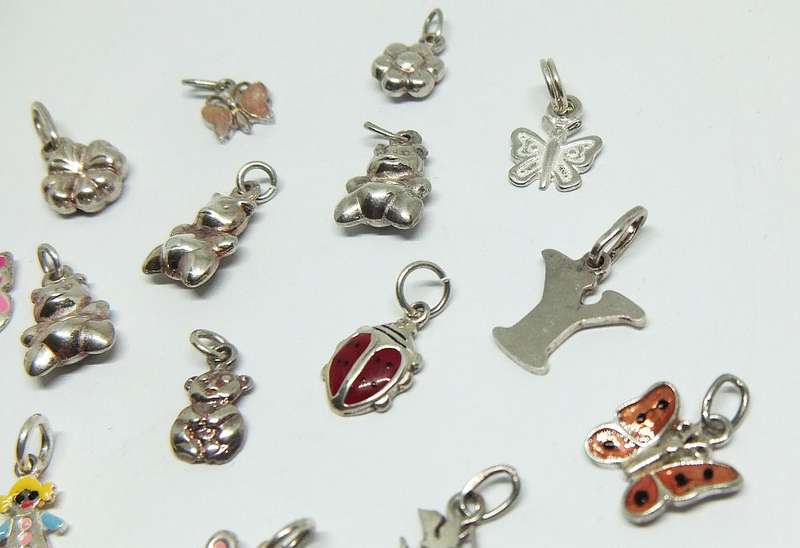 WOW !! AN ADORABLE LOT OF 19 STERLING SILVER CHARMS !! BID FOR THE LOT !!