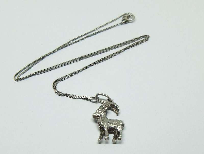 A VINTAGE ITALIAN STERLING SILVER NECKLACE WITH A SOLID GERMAN " 835 "SILVER GOAT PENDANT