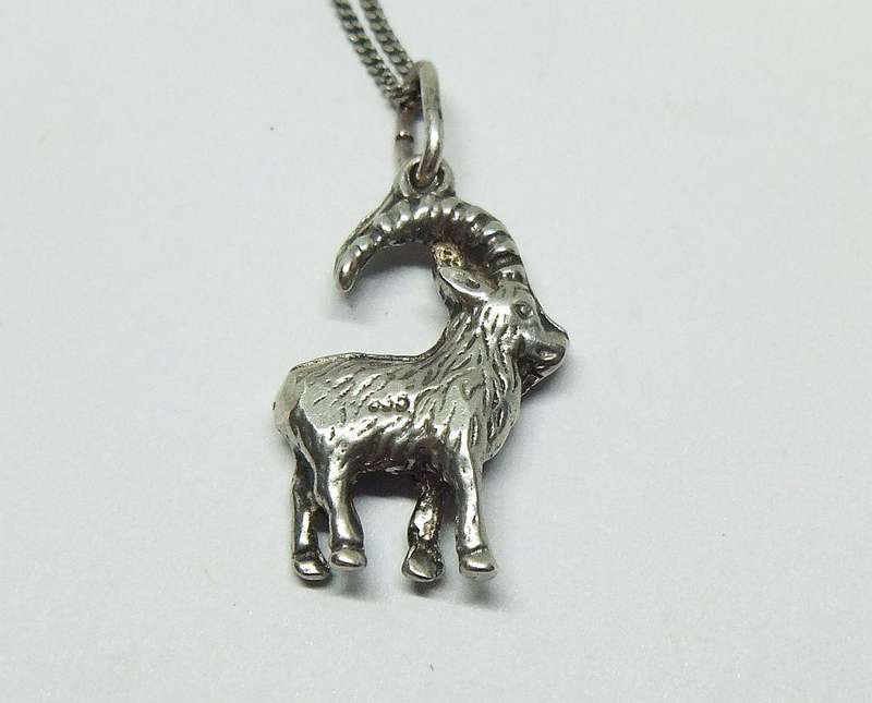 A VINTAGE ITALIAN STERLING SILVER NECKLACE WITH A SOLID GERMAN " 835 "SILVER GOAT PENDANT