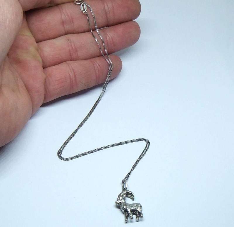 A VINTAGE ITALIAN STERLING SILVER NECKLACE WITH A SOLID GERMAN " 835 "SILVER GOAT PENDANT