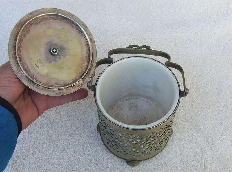 A VICTORIAN ERA PORCELAIN JAR WITH METAL FRAME , HANDLE AND LID MARKED EPNS