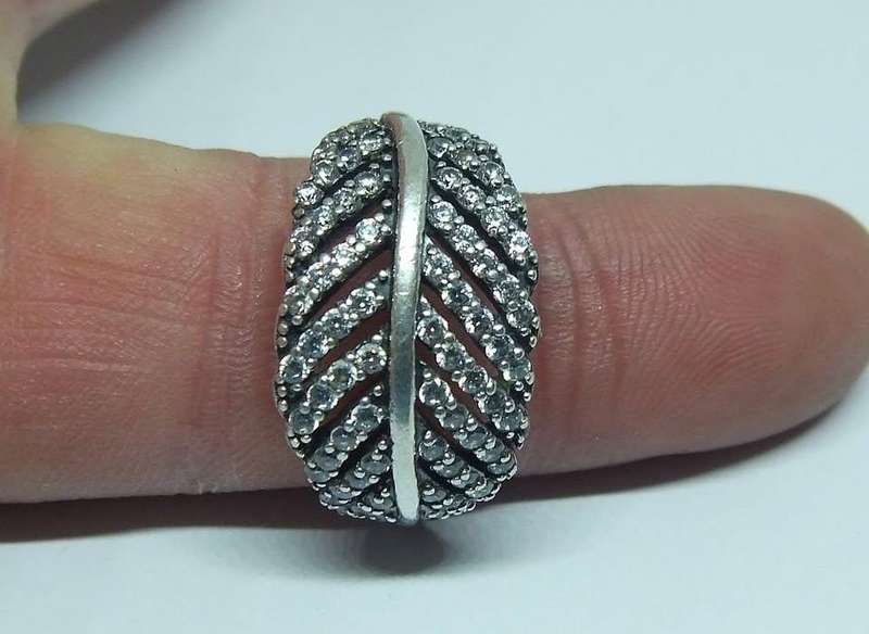 A BEAUTIFUL SOLID STERLING SILVER RING SET WITH OVER 80 FACETED CZ STONES IN EXCELLENT CONDITION !!