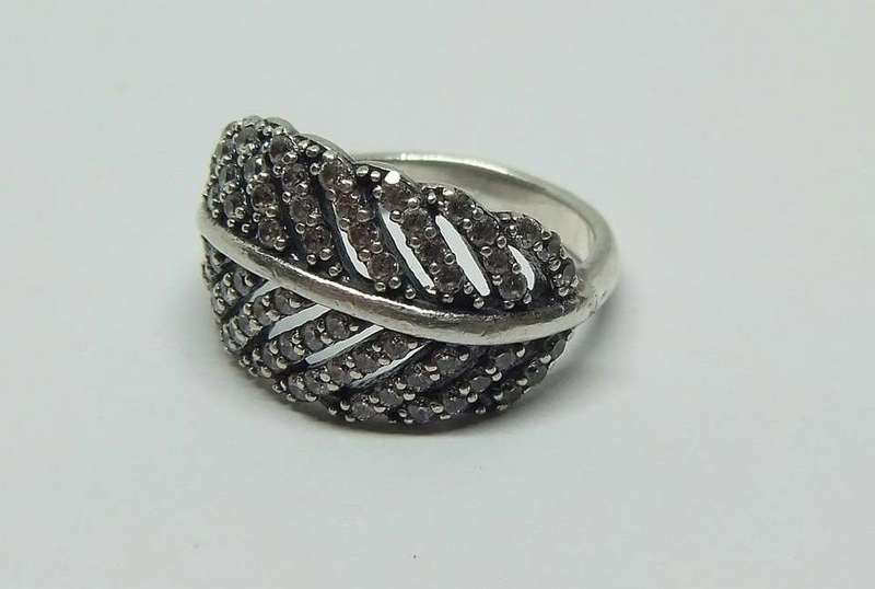 A BEAUTIFUL SOLID STERLING SILVER RING SET WITH OVER 80 FACETED CZ STONES IN EXCELLENT CONDITION !!
